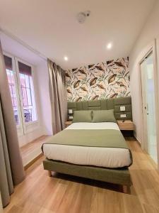a bedroom with a bed with a mural on the wall at Hostal San Blas in Madrid