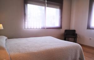 Postel nebo postele na pokoji v ubytování Apartamentos Ronda Luz + 37 fotografií