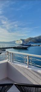 a cruise ship is docked at a dock in the water at CELEBRITY Hotel in Argostoli