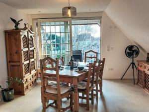 a dining room with a wooden table and chairs at Apartment Casa Ela by Interhome in Bodenwerder