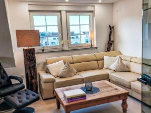a living room with a couch and a coffee table at Apartment Casa Ela by Interhome in Bodenwerder