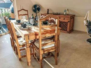a wooden table with chairs and a dining room at Apartment Casa Ela by Interhome in Bodenwerder +30 photos