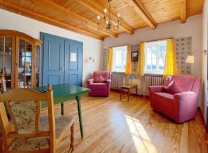 a living room with two chairs and a table at Haus-Wolfram-App-Wilhelmine in Morsum