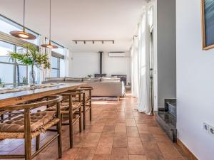 a dining room with a long table and chairs at Holiday Home El Refugio del Viento by Interhome in El Poblenou del Delta +29 photos