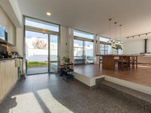 a kitchen and dining room with a dining table and a large window at Holiday Home El Refugio del Viento by Interhome in El Poblenou del Delta