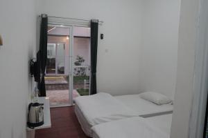 Katil atau katil-katil dalam bilik di Sambas Cottages
