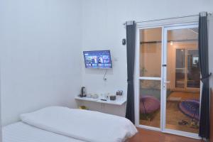 Katil atau katil-katil dalam bilik di Sambas Cottages