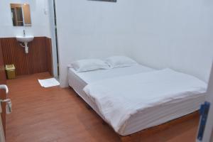 Katil atau katil-katil dalam bilik di Sambas Cottages