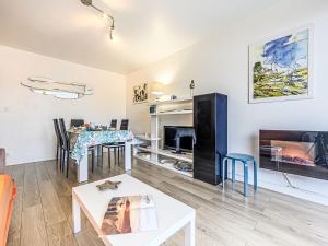 a living room with a table and a dining room at Apartment Le Zal-4 by Interhome in Quiberon