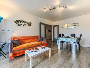 a living room with a couch and a table at Apartment Le Zal-4 by Interhome in Quiberon