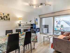 a dining room and living room with a table and chairs at Apartment Le Zal-4 by Interhome in Quiberon +16 photos