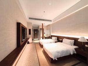 Krevet ili kreveti u jedinici u okviru objekta Chengdu Guiyuan Hotel