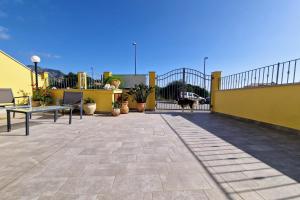 a patio with a dog standing on a balcony at Sa Mamma e Sole in Cala Gonone