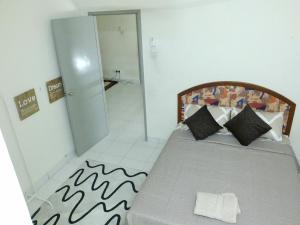 a bedroom with a bed and a door to a hallway at Dillenia Nilai Homestay in Nilai