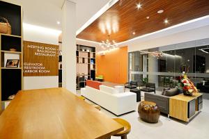 a living room with a table and a couch at TreePark Banjarmasin in Banjarmasin