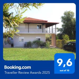 a picture of a house with a car in front at Casa De Vara in Nea Potidaea