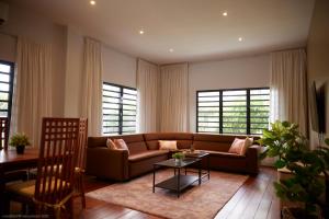 a living room with a couch and a table at Tropical Villa Rainville in Paramaribo