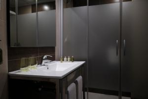 a bathroom with a sink and a shower at Helios Benidorm in Benidorm