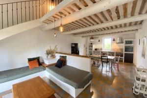a living room with a couch and a dining room at 84B6 - Loft in charming 18th century farmhouse in Althen-des-Paluds