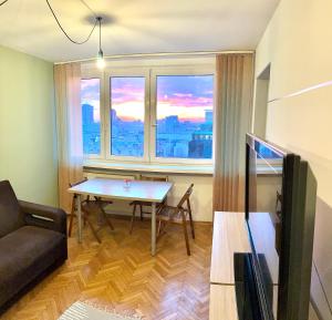 a living room with a table and a large window at Intercontinental Escape in Warsaw +5 photos