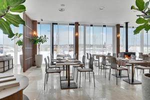 a restaurant with tables and chairs and a fireplace at GRANO HOTEL Solmarina in Wiślinka