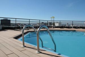 a swimming pool on the roof of a building at Holiday Inn Lisbon by IHG in Lisbon