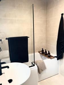 a bathroom with a toilet and a sink and a bath tub at Boho Bay Two - Seaside Escape in Cullercoats +22 photos