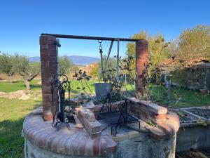 a stone wall with a fireplace in a yard at L'Oasi della Fonte in Albanella