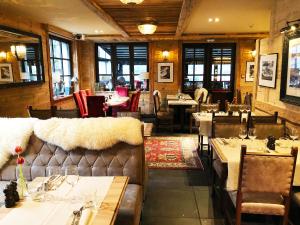 a restaurant with tables and chairs in a room at Hotel Le Castel in Chamonix