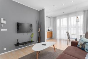 a living room with a couch and a table at City Comfort Apartments in Reykjavík