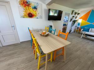 a dining room with a wooden table and chairs at Casita Está Aquí in Urcal +10 photos