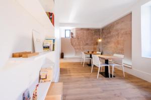a room with a table and chairs and a staircase at Tour de la Fournache in Saint-Jean-de-Maurienne