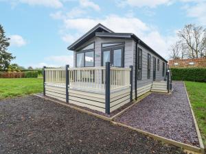 a tiny house sitting on a gravel lot at Wurzburc in Swaffham