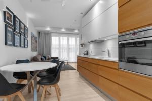 a kitchen and living room with a table and chairs at City Comfort Apartments in Reykjavík