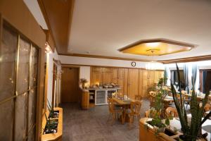 a kitchen and dining room with a table and chairs at Hotel Liederbacher Hof in Liederbach am Taunus