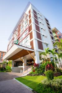 a large white building with a balcony at Crystal Jade Hotel in Rayong