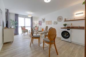 a kitchen and dining room with a table and chairs at Résidence de Nogent sur Marne in Nogent-sur-Marne