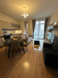 a living room with a table and a couch at SISI Apartment in Tirana
