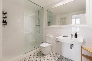 a bathroom with a toilet and a sink and a shower at Ola Living Arc de Triomf in Barcelona +31 photos