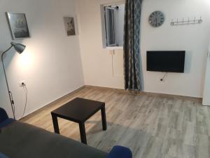 a living room with a table and a tv on a wall at Vista Puerto Studio 1 Pers No balcon in Arguineguín