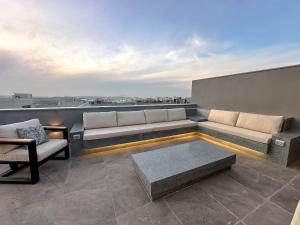 a living room with a couch and chairs on a roof at velora Studio roof in sodic villette compound in New cairo +31 photos