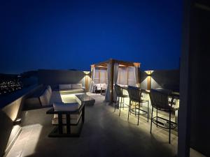 a rooftop deck with chairs and a tent at night at velora Studio roof in sodic villette compound in New cairo