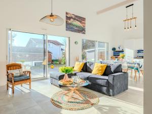 a living room with a couch and a table at Holiday Home Domaine de Peyroutic by Interhome in Aureilhan