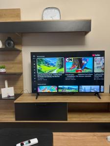 a flat screen tv sitting on top of a table at SISI Apartment in Tirana