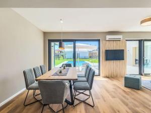 a dining room with a table and chairs at Villa Chiara by Interhome in Brtonigla +34 photos