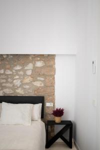 a bedroom with a bed and a brick wall at El Corral de Jirueque in Jirueque +16 photos