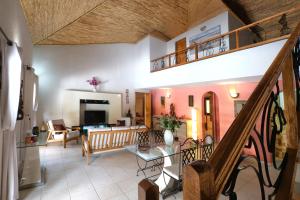 a living room with a staircase and a living room at Villa Nianing in Nianing