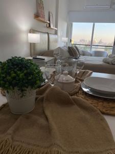 een woonkamer met een tafel met borden en een bank bij Departamento sobre el Rio. in Corrientes