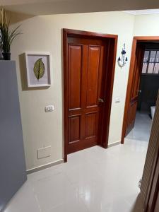 a hallway with a wooden door and a tile floor at Boca chica retreat in Boca Chica +11 photos