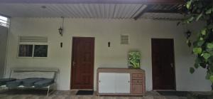 a room with two doors and a dresser in it at Ceylon Shine in Kandy